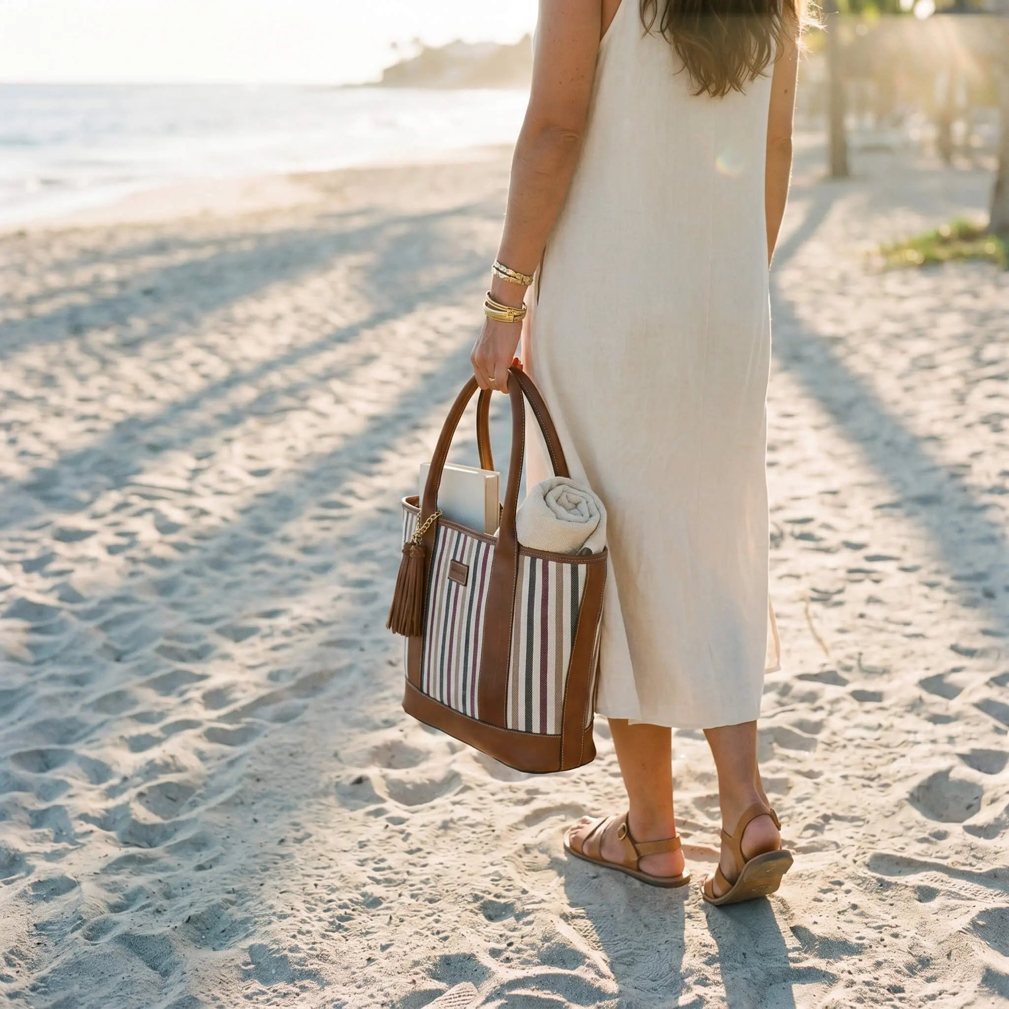 Riviera Carryall Tote — multicolour striped canvas & tan leather — packed for the beach | Sangre de Mar handcrafted leather
