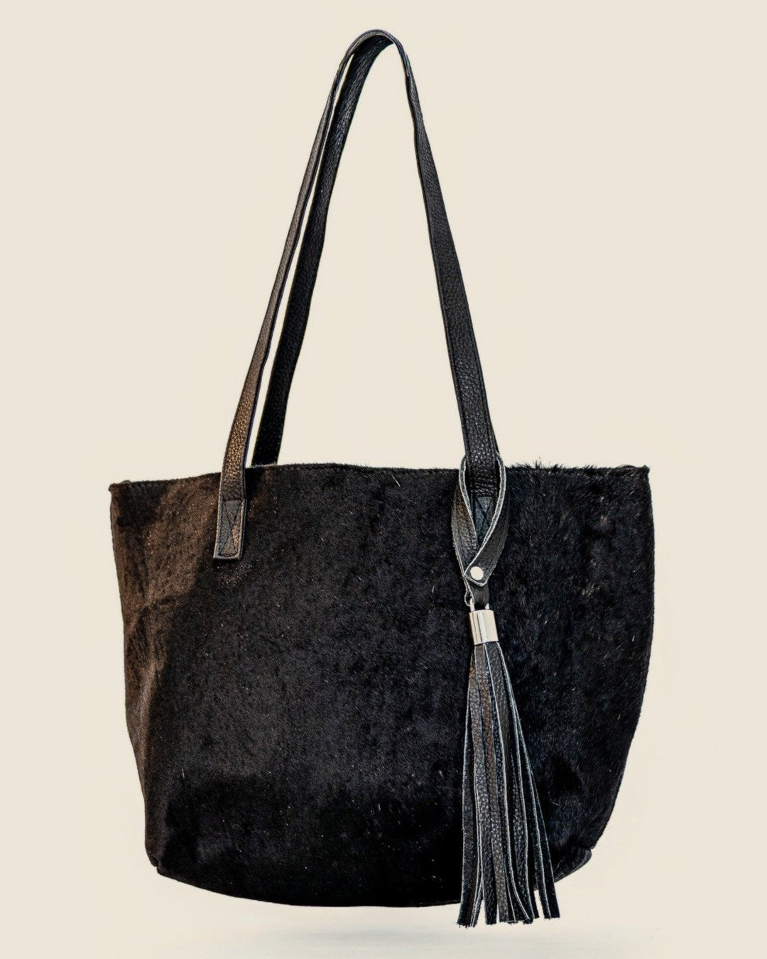 Atlantica Hair-on-Hide Tote — black hide with silver-capped leather tassel — front | Sangre de Mar handcrafted leather