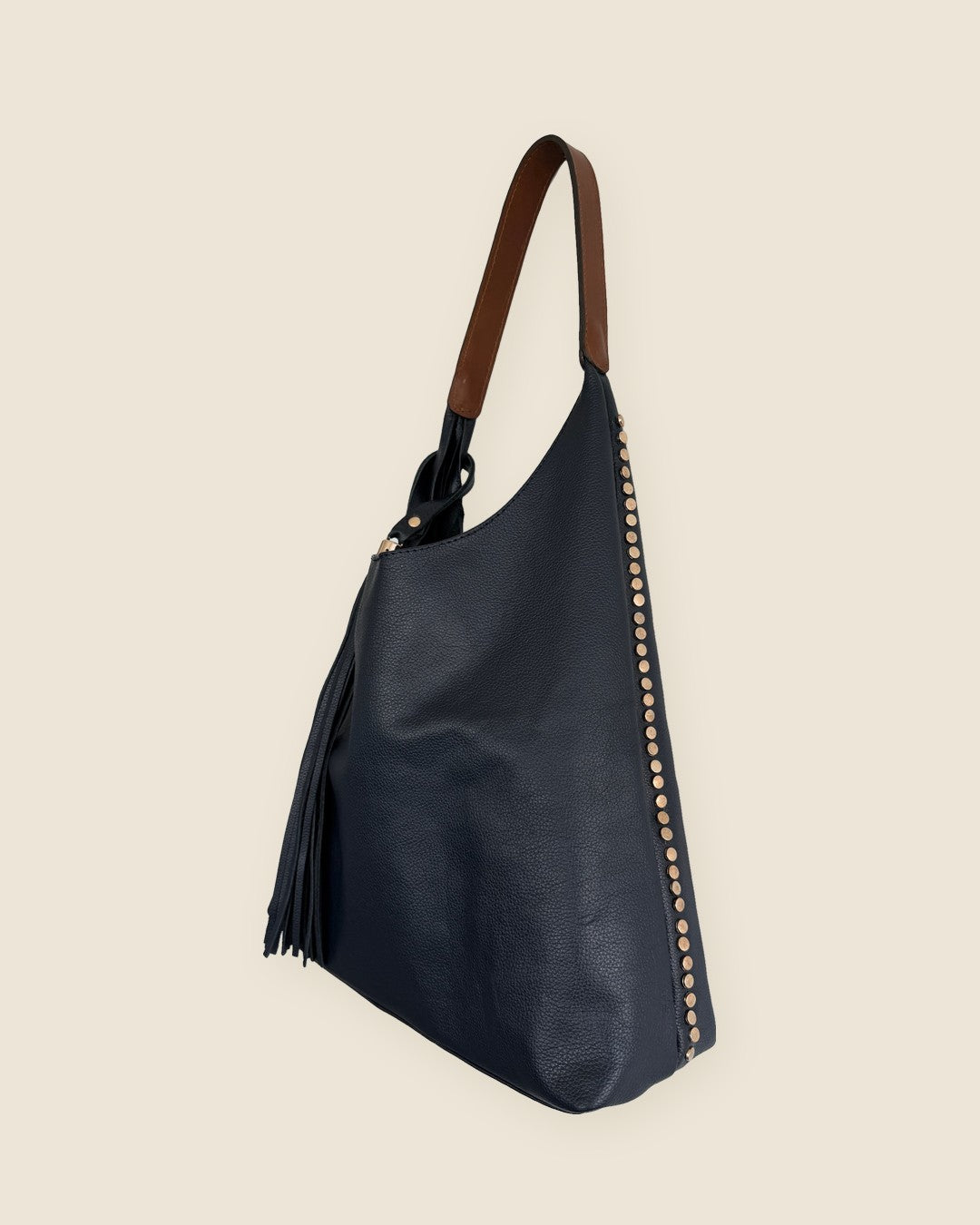 Sienna Hand-Finished Tote — navy full-grain leather with hand-pressed studs along the seam, tan strap — side | Sangre de Mar handcrafted leather #Colour_Navy · Tan strap